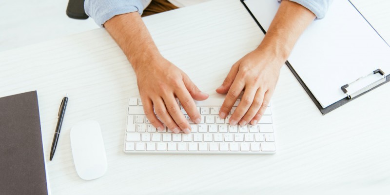 Partners Finances broker typing on computer keyboard